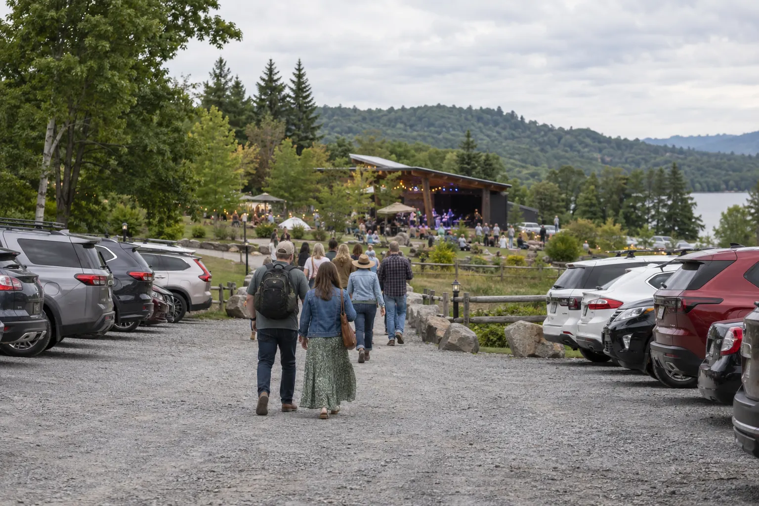 Visitors walking toward an outdoor venue from a parking area